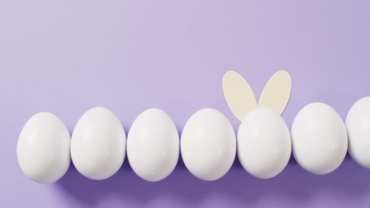 복사 공간과 함께 보라색 배경에 토끼 귀와 함께  ⁇  이스터 달 ⁇