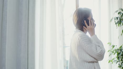 woman talking on phone at home