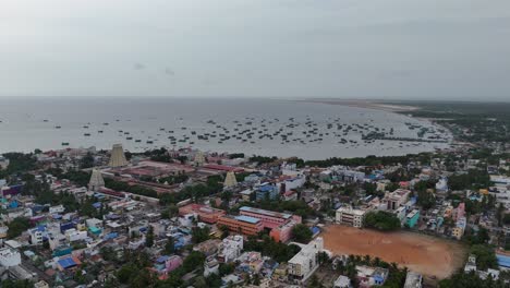 aerial view of coastal city with temple and fishing boats in india