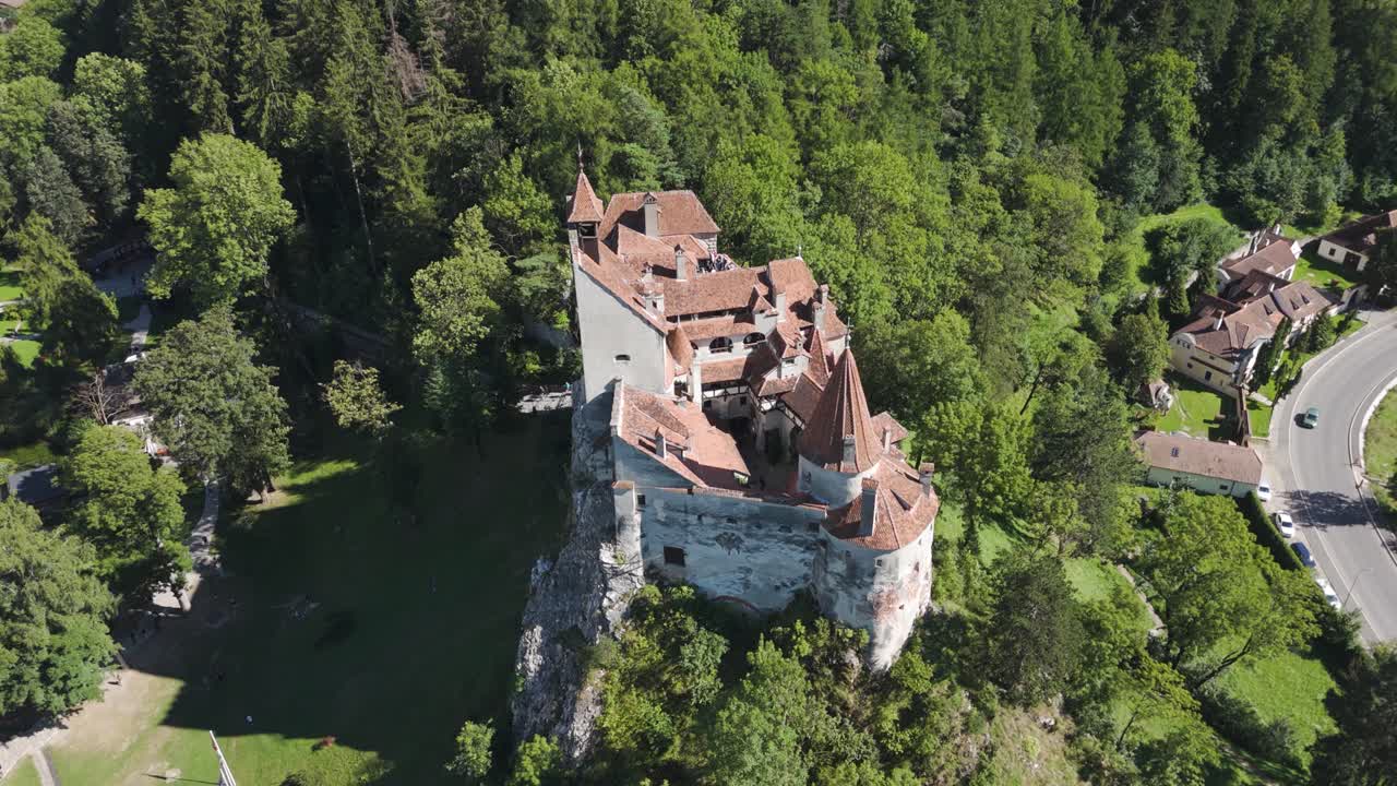 Orbiting Bran Castle with scenic views of the green Transylvanian landscape
