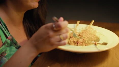 woman talking and eating gourmet dinner at the restaurant