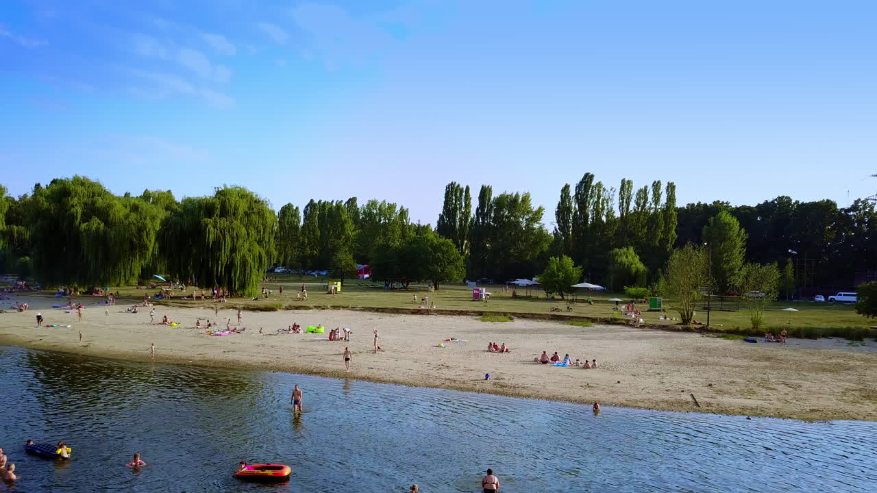 River Beach Scene with People Enjoying Summer Day