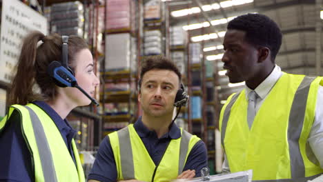 Warehouse-staff-discussing-orders-with-manager,-shot-on-R3D