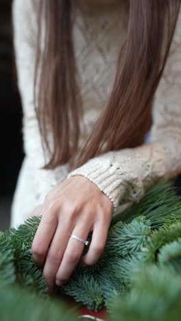 woman making a christmas wreath