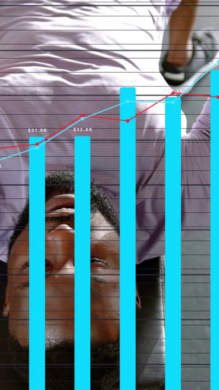 Vertical video: Man on bench pressing weights while overlay starting revenue bars rising over chest