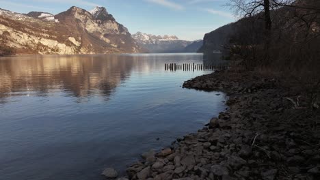 walensee, switzerland, stunning lakeshore with crystal-clear water, rugged rocks and breathtaking alpine mountains.