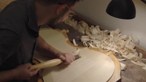 luthier creating violin in workshop