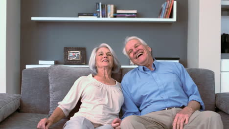 Retired-couple-flopping-down-on-the-couch