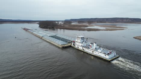 approaching lansing, iowa, a towboat pushing barges north on the mississippi river-7