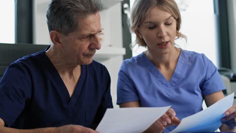 Two-caucasian-doctors-talking-in-the-office.