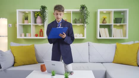 Little-boy-in-jacket-and-tie-plays-like-a-businessman.