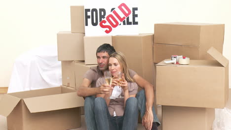 couple in new house drinking champagne