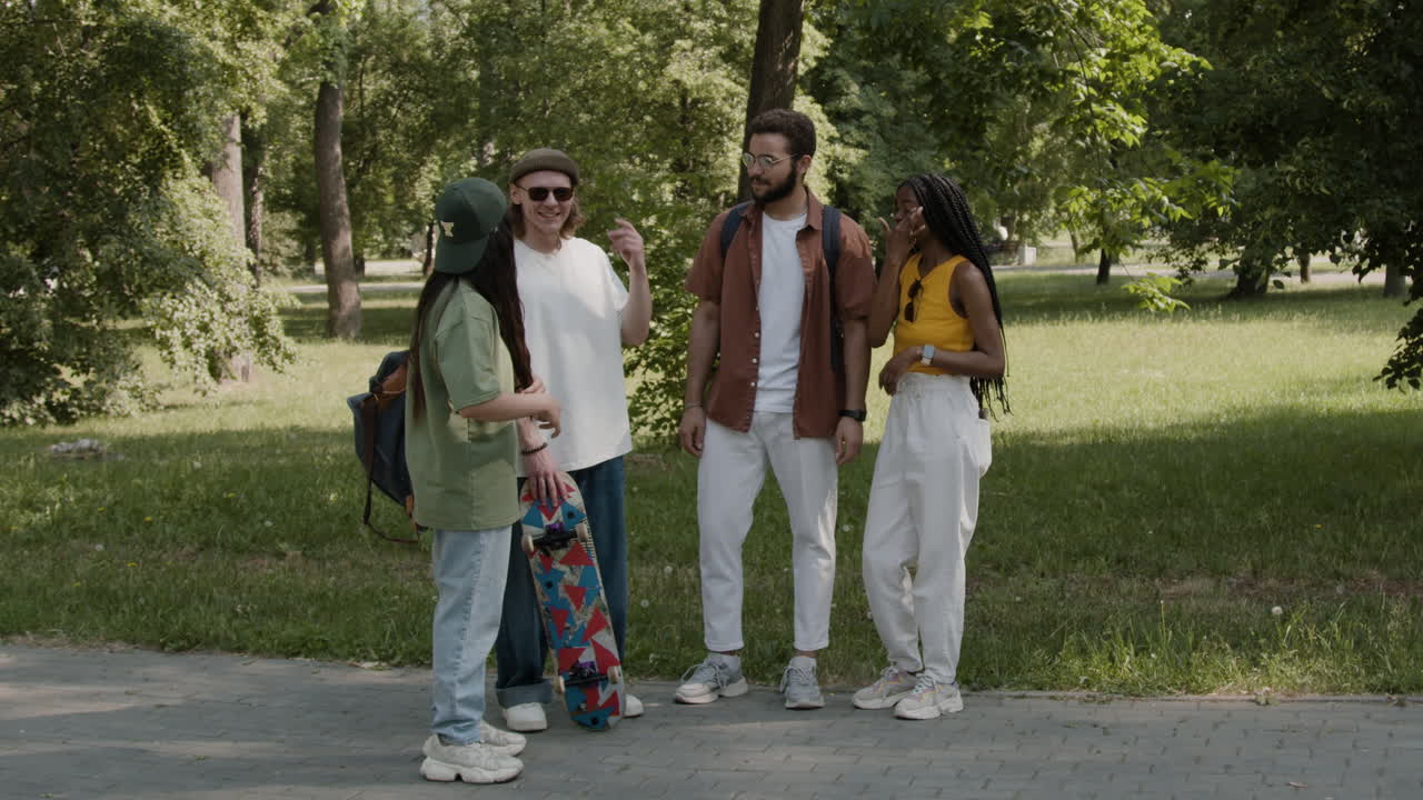 Young Adults Socializing and Talking in a Park