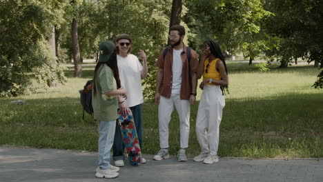 young adults socializing and talking in a park