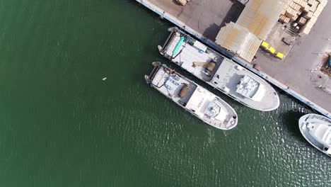 Aerial-view-above-Spain-harbour-moored-boats-along-waterfront