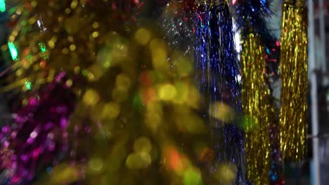 carnival with ferris wheel, bright colourful lights, car carousel at night closeup