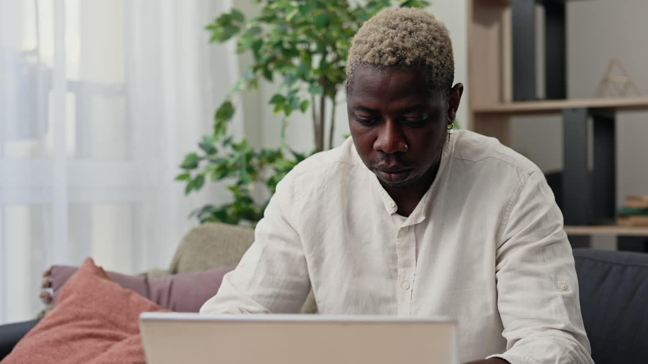 Man Working on Laptop at Home