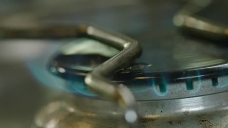 shallow focus macro shot of a gas cooker hob burning blue