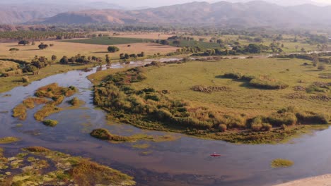 aerial view lone kayak paddling in scenic monterry valley river in la hausteca, mexico wilderness