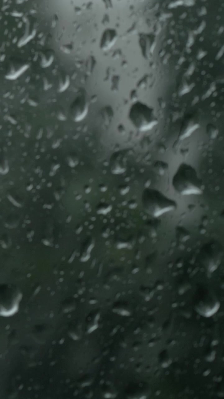Summer rainstorm outside, view through the window