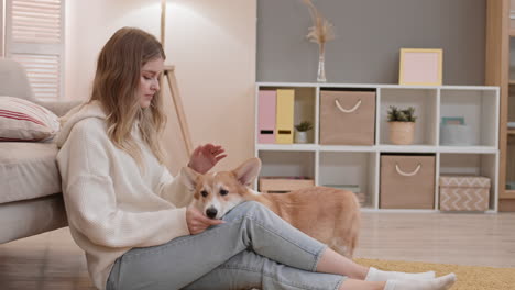 blond woman with corgi at home