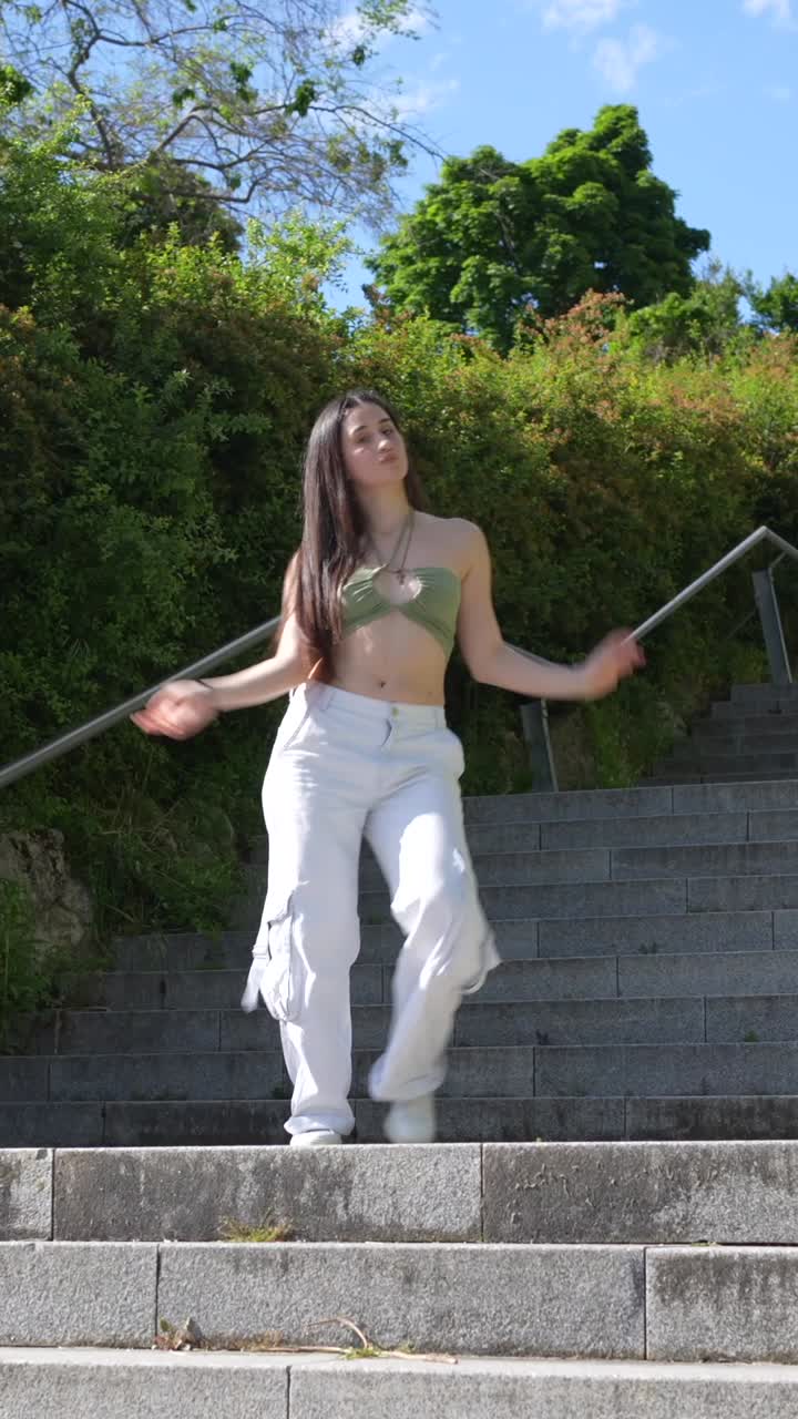 Woman dancing on stairs outdoors