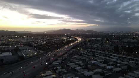 Descending-drone-shot-of-rush-hour-highway-after-sunset