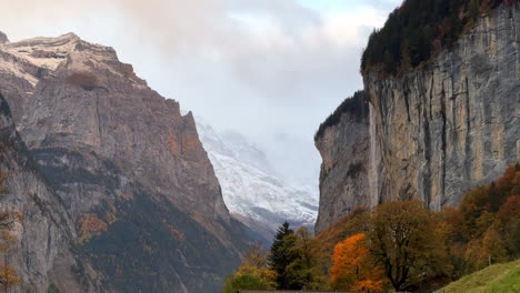 Staubbach-Falls-Lauterbrunnen-Switzerland-Swiss-alpine-valley-village-Jungfrangu-Grindelwalk-Interlaken-Bernese-Alp-sunset-golden-hour-autumn-October-colors-snow-glacier-gigantic-rock-face-static-shot