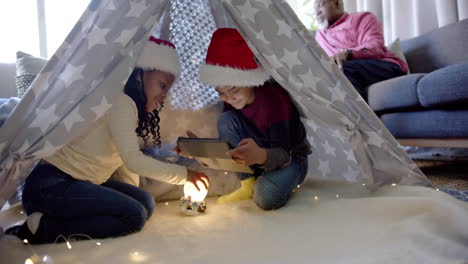 montage of happy multi generation african american family at home together during christmas time