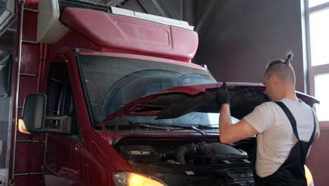 mechanic working on a van engine in a garage