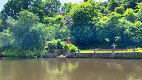 small wind water by by a river for pumping water to the garden