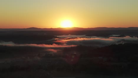 sunrise over misty mountains