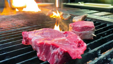 Ribeye-steak-on-charcoal-grill-with-flame