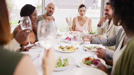 Diverse-group-laughing-at-a-party-enjoying