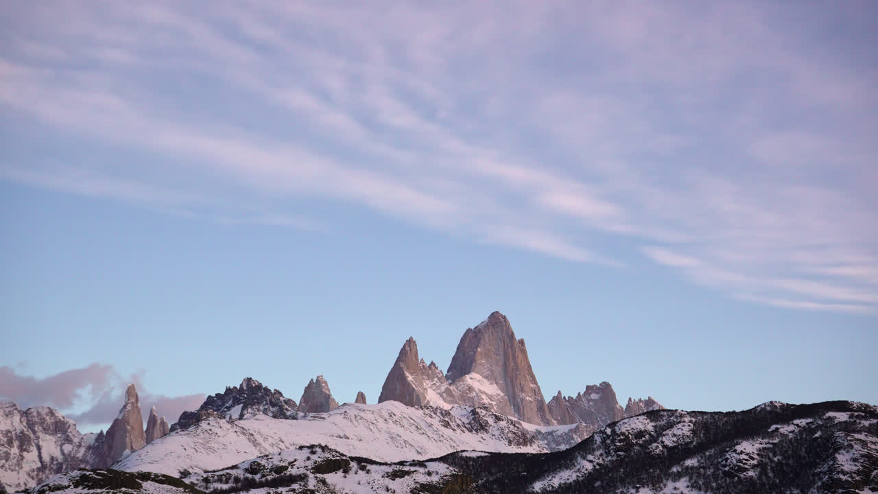 Timelapse of mount Fitz Roy and Cerro Torre just before sunrise with clear skies and serene landscape in Patagonia