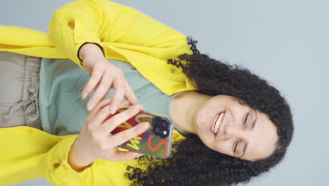 vertical video of young woman making a video call on the phone.