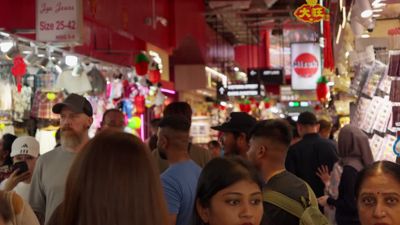 Busy shoppers and tourists fill vibrant Bugis Street in Singapore's Central Region on a bustling day