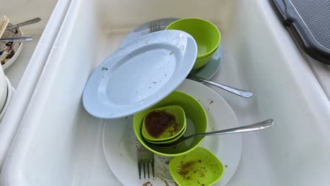 sequence of dirty to clean dishes in a sink.