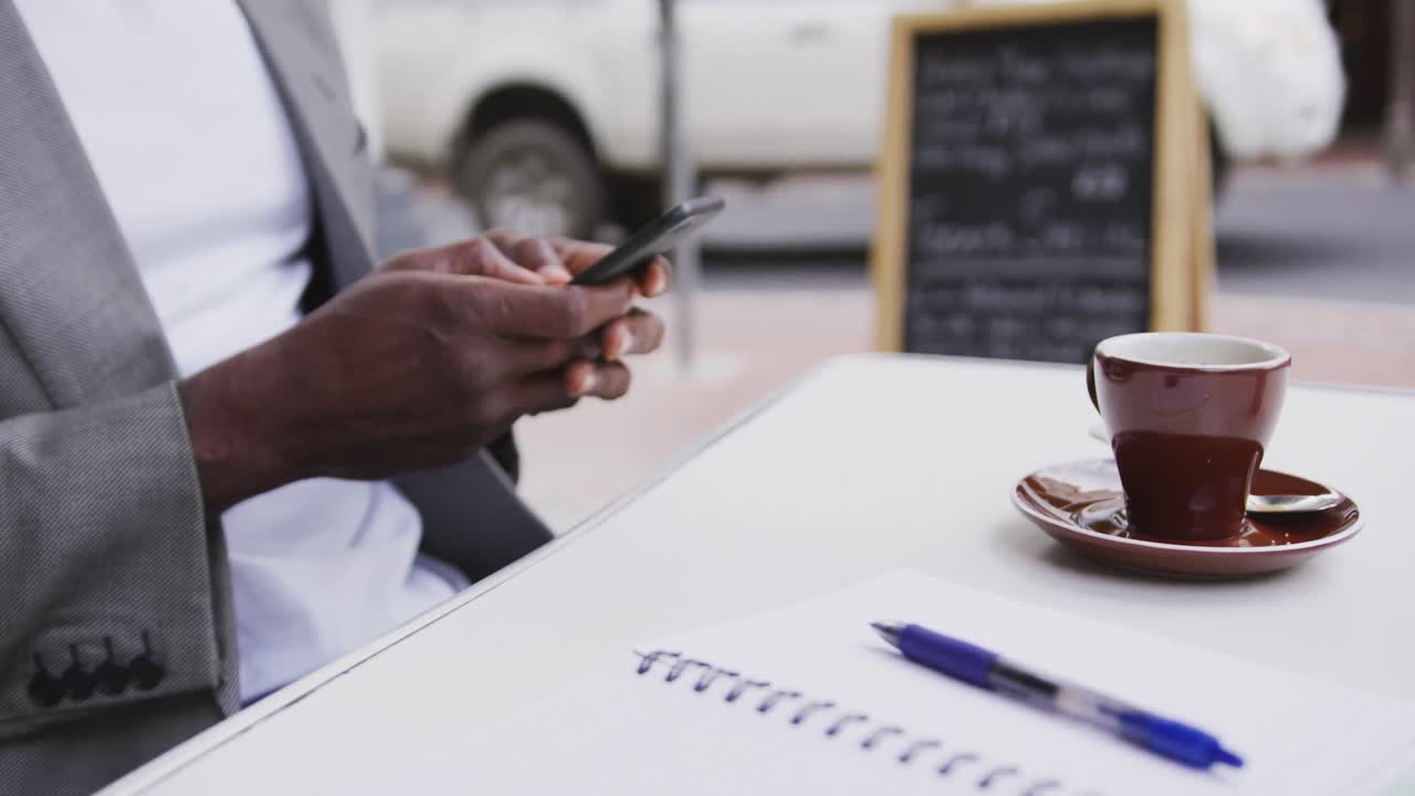 African American man using his phone in a coffee