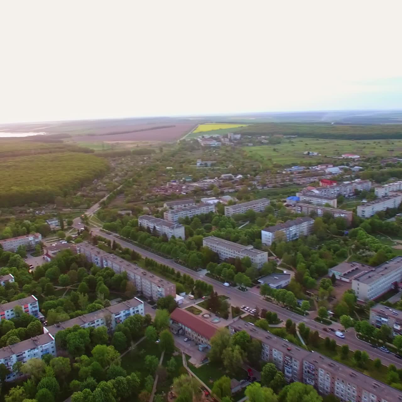 Town blocks of flats locating in the beautiful green area. Fantastic little cityscape with fine nature at backdrop. Aerial view