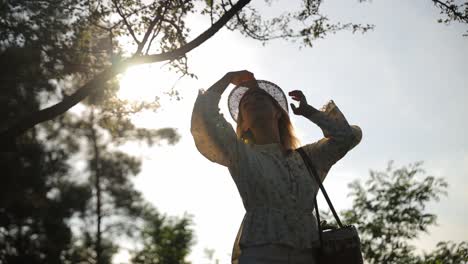 laughing joyfully, woman enjoying sunny day outdoors in park, feeling happy. happiness, nature, sunlight, relaxation, leisure, freedom