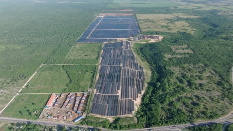 aerial high angle view on solar panel park surrounded by forest landscape at sunny day