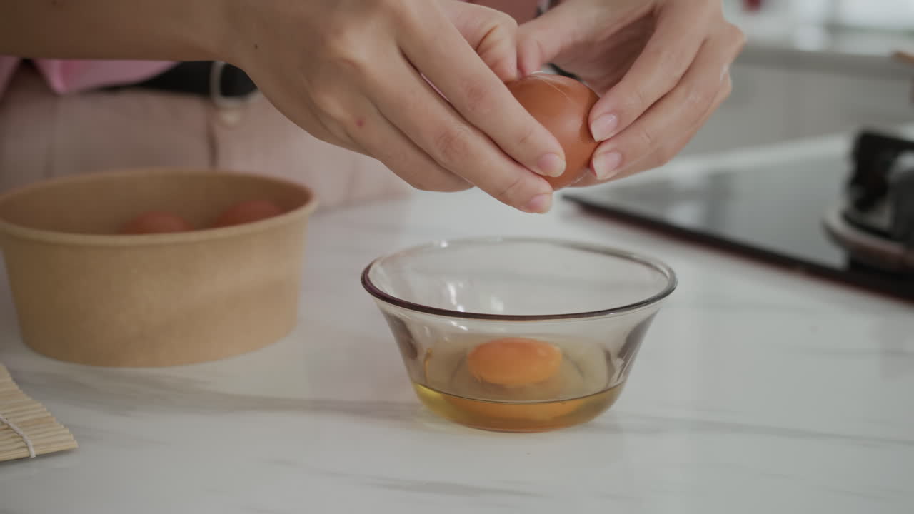 Hands of Girl Cracking Eggs in Bowl for Dish