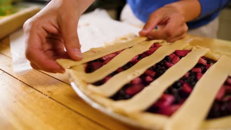 close-up-cutting-slices-of-dough-for-covering-the-top-of-a-pie