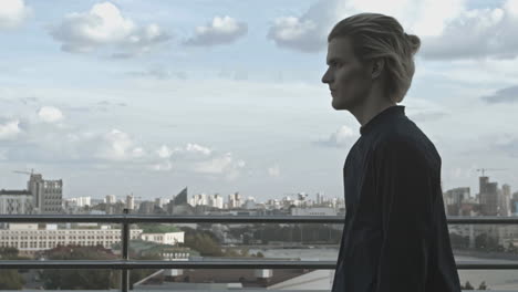 cityscape view with a man walking on a rooftop