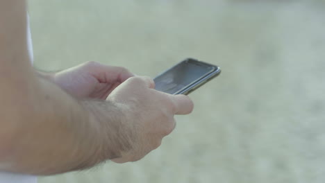 Closeup-shot-of-male-hands-typing-message-on-smartphone.