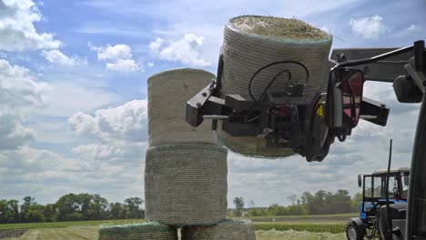 máquinas agrícolas que transportan rollos de paja en el campo de cultivo.