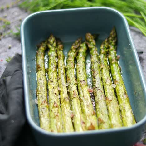 roasted asparagus seasoned with salt  pepper  garlic and decorated with fresh herbs