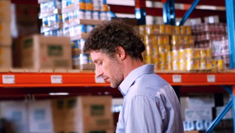 businessman standing and checking inventory stock