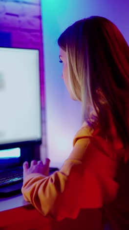 young female student using a desktop computer